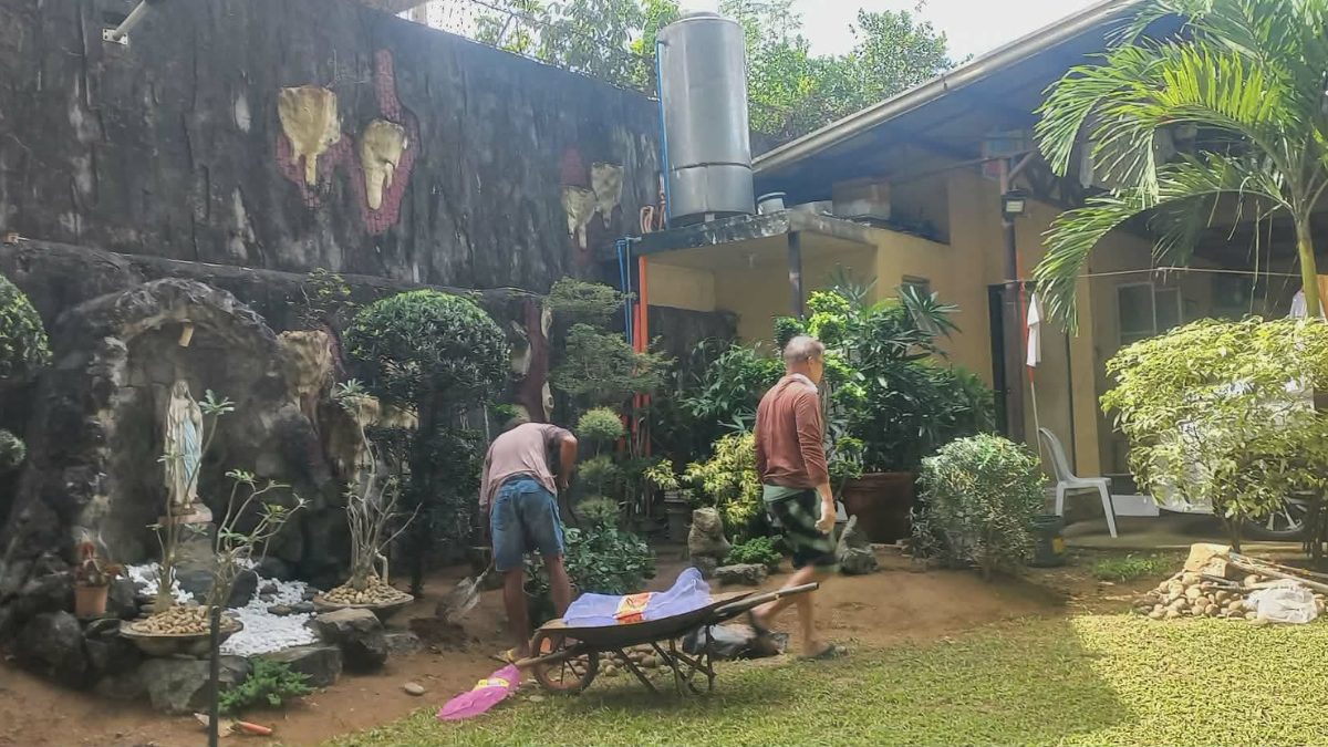 Workers maintaining grotto garden
