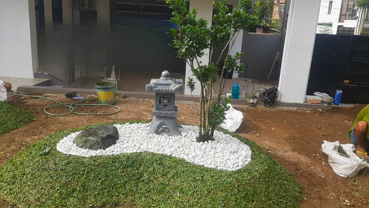 Japanese lantern focal point with white pebbles